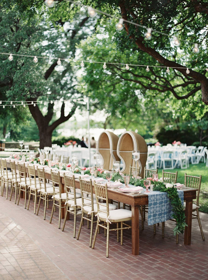 Outdoor wedding reception with decorated tables and string lights