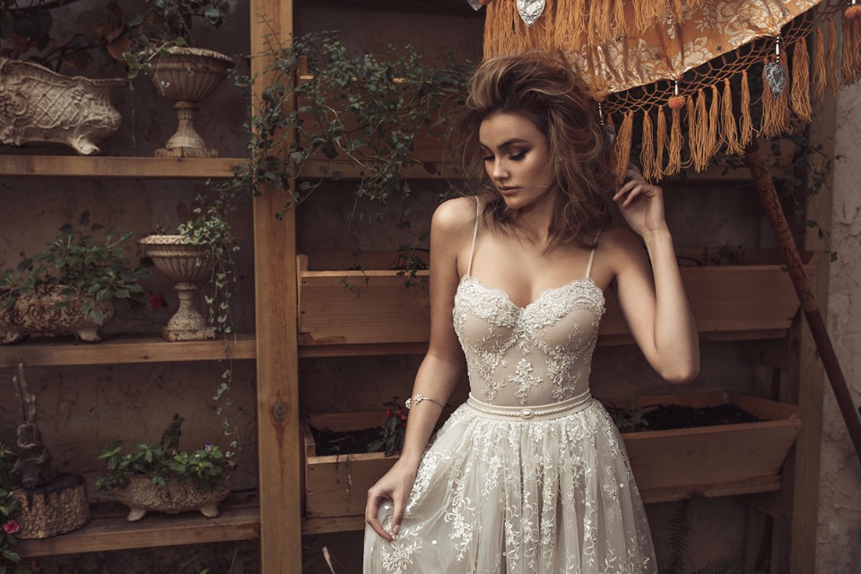 Elegant bride in a stunning lace wedding dress, garden background