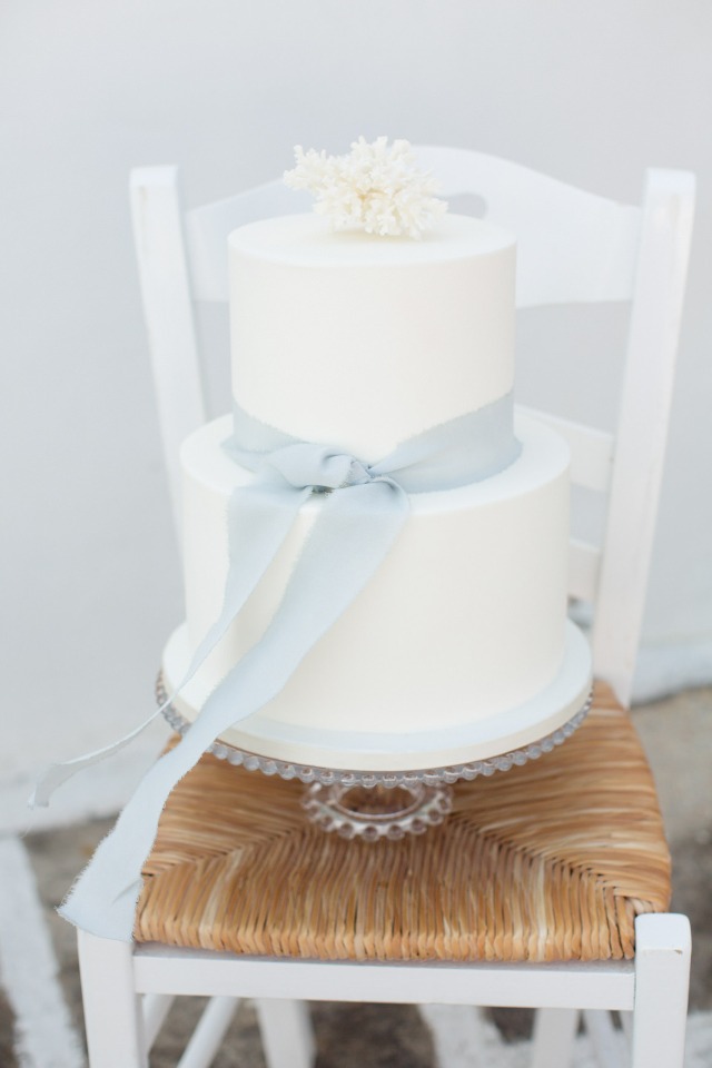 Simple white wedding cake with blue ribbon