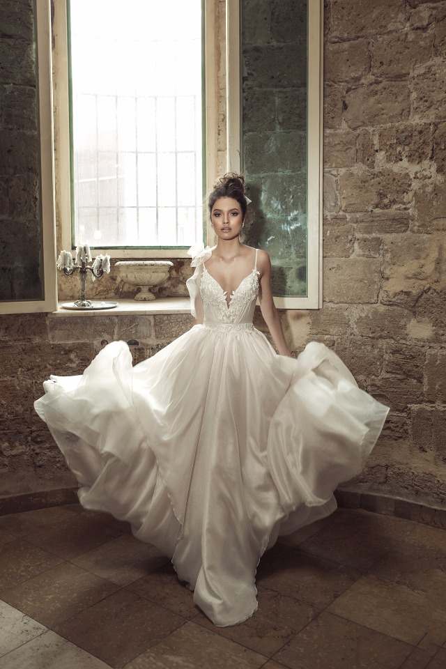 Bride in a flowing wedding dress in a historic building