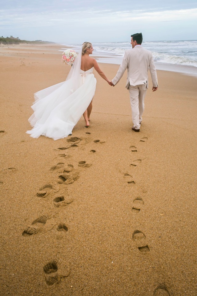 Newlyweds walking on the beach