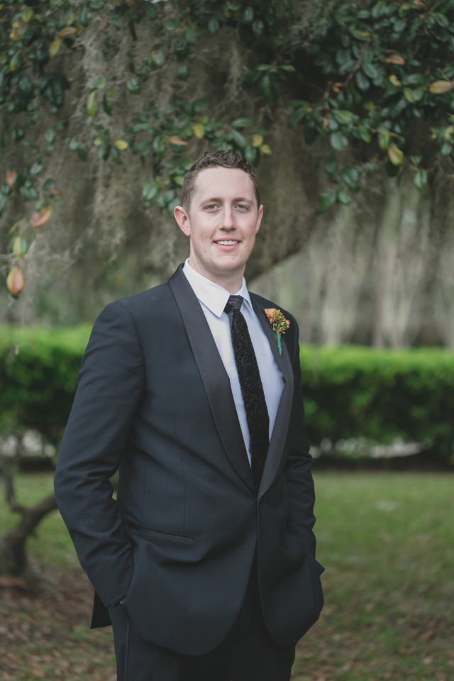 groom in tuxedo suit in black and white