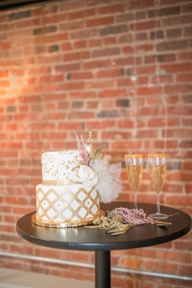 gold and white wedding cake and champagne