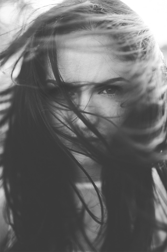 Black and white portrait of a woman with windblown hair
