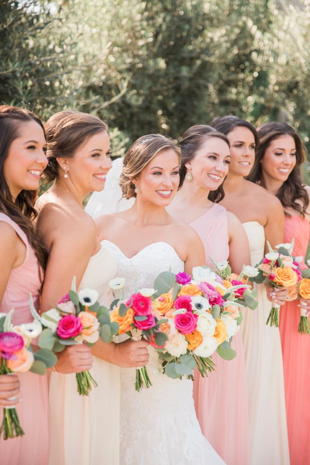 pink and peach bridesmaids with pink and yellow bouquets