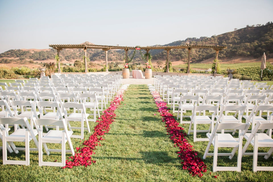 vineyard wedding ceremony with rose petals
