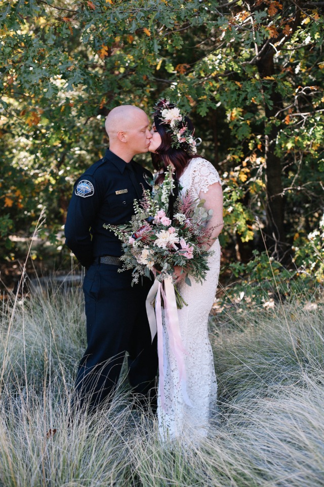 Romantic wedding kiss man in uniform bride outdoors
