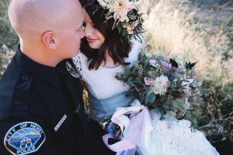 Bride and police officer wedding day portrait outdoors