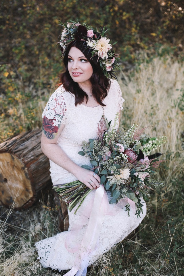Bride with flower crown and bouquet at woodland wedding