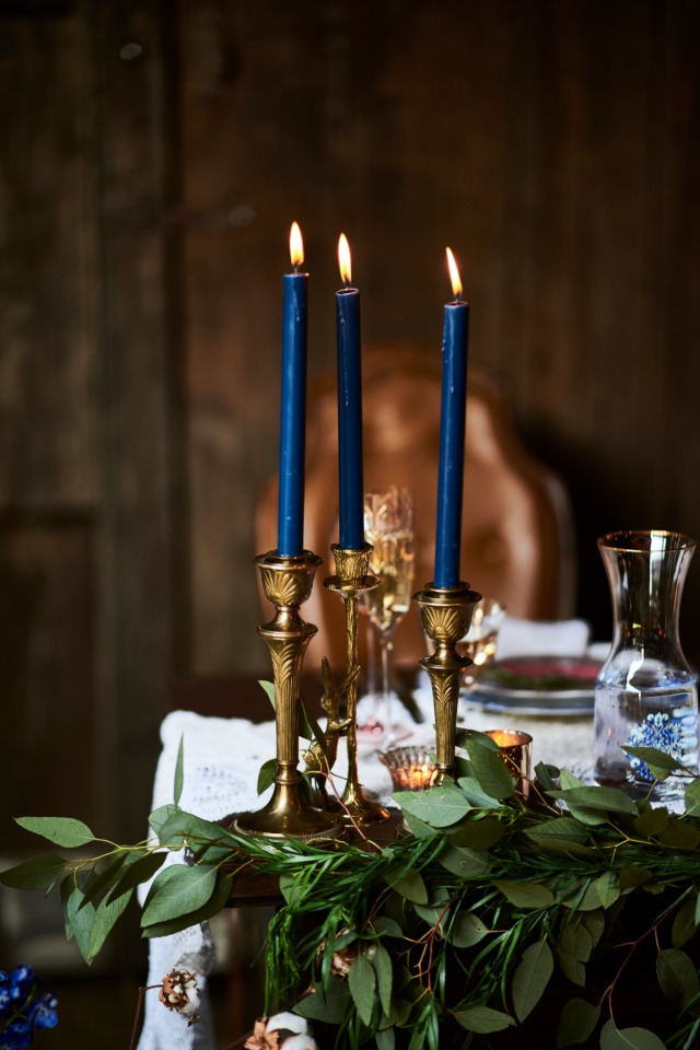 royal blue candles in brass candle sticks
