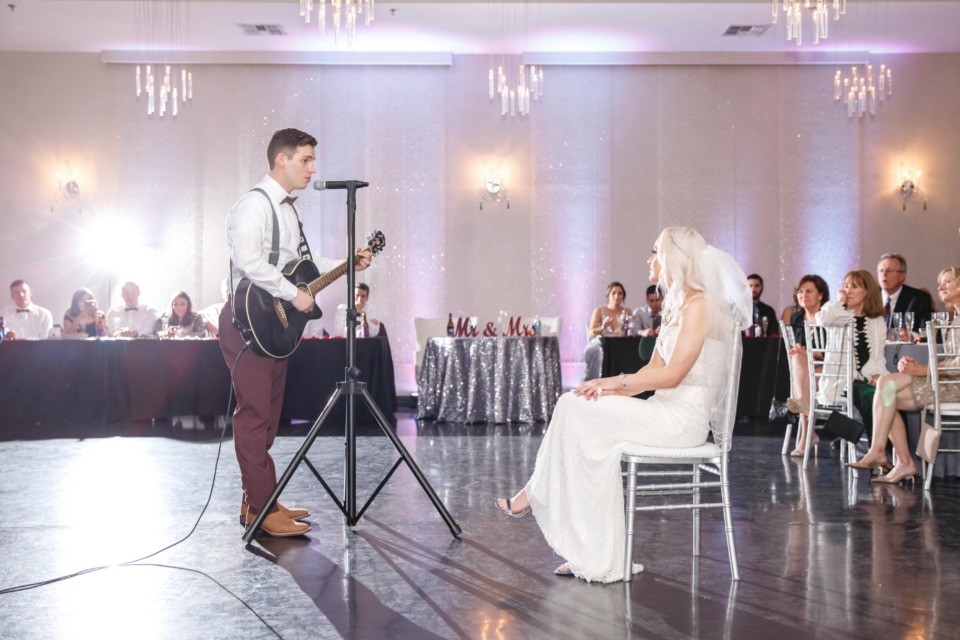 Groom serenading his bride
