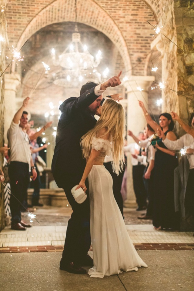 Sparkler sendoff: Bride and groom kiss