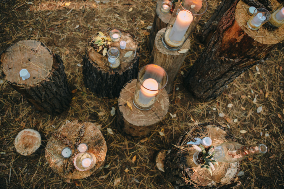 candles and tree stump wedding ceremony decor