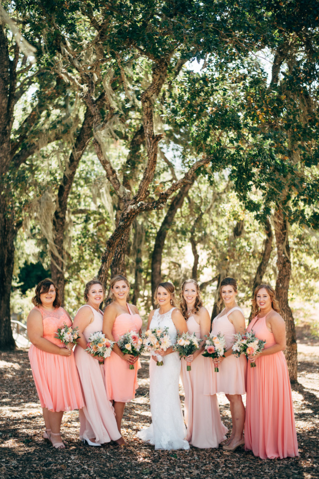 Bride and bridesmaids in peach dresses, outdoor wedding