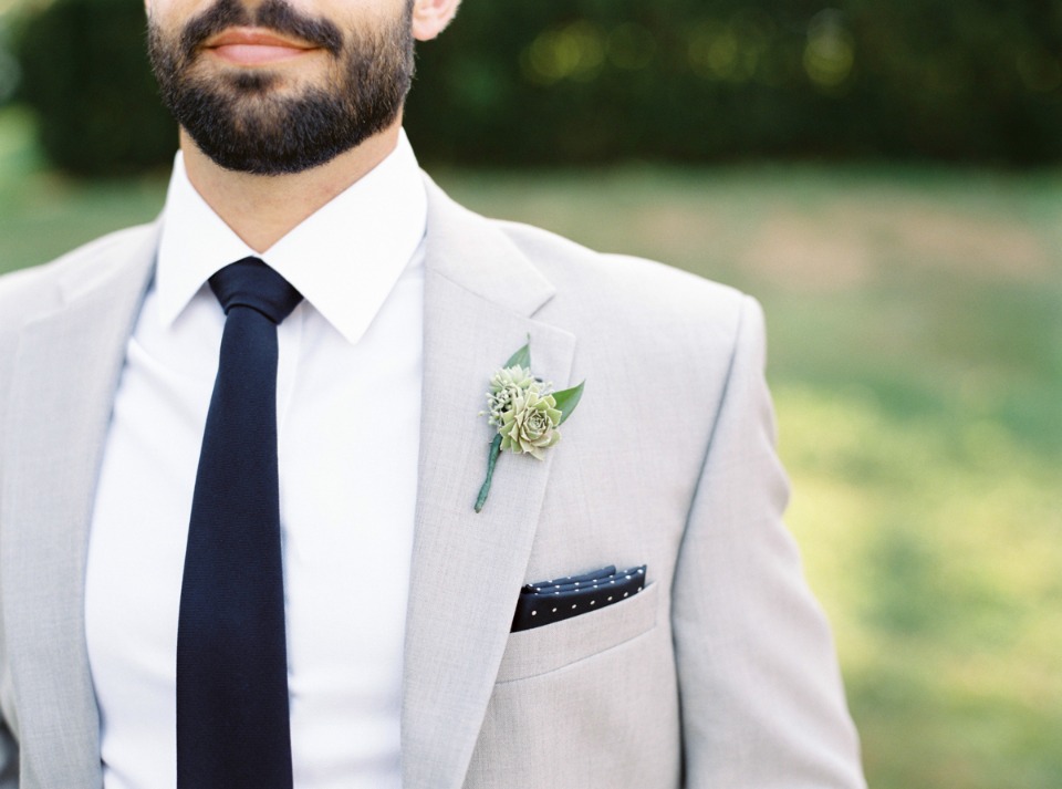 Light grey suit with a dark tie