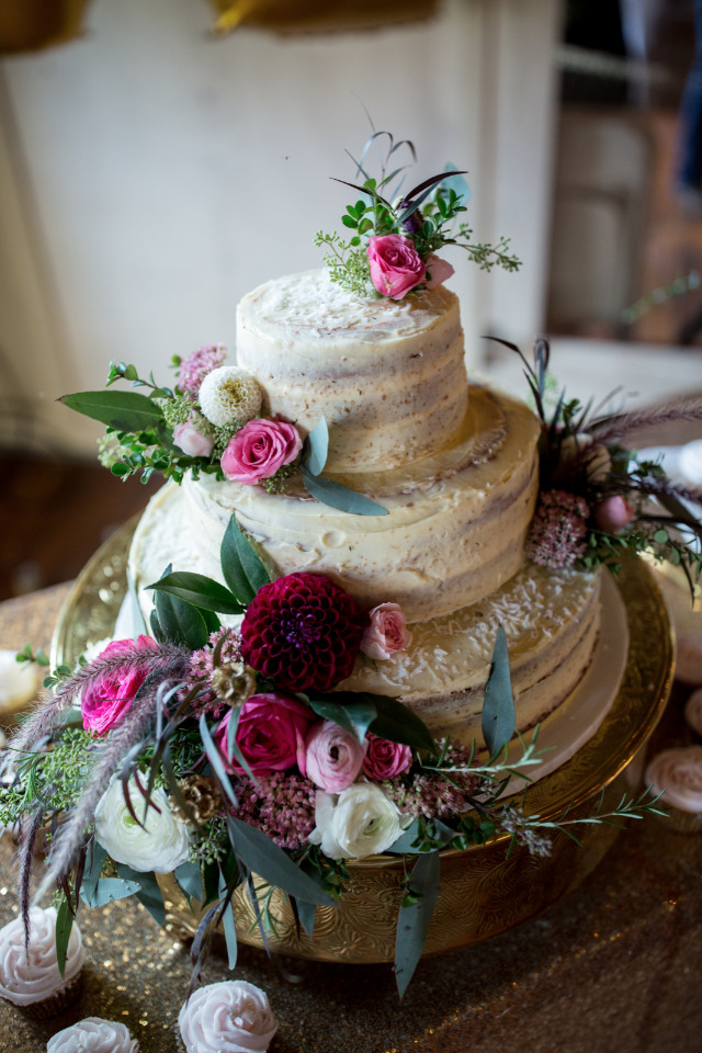 almost naked wedding cake with flowers