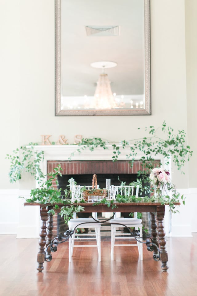wedding sweetheart table in front of a fireplace