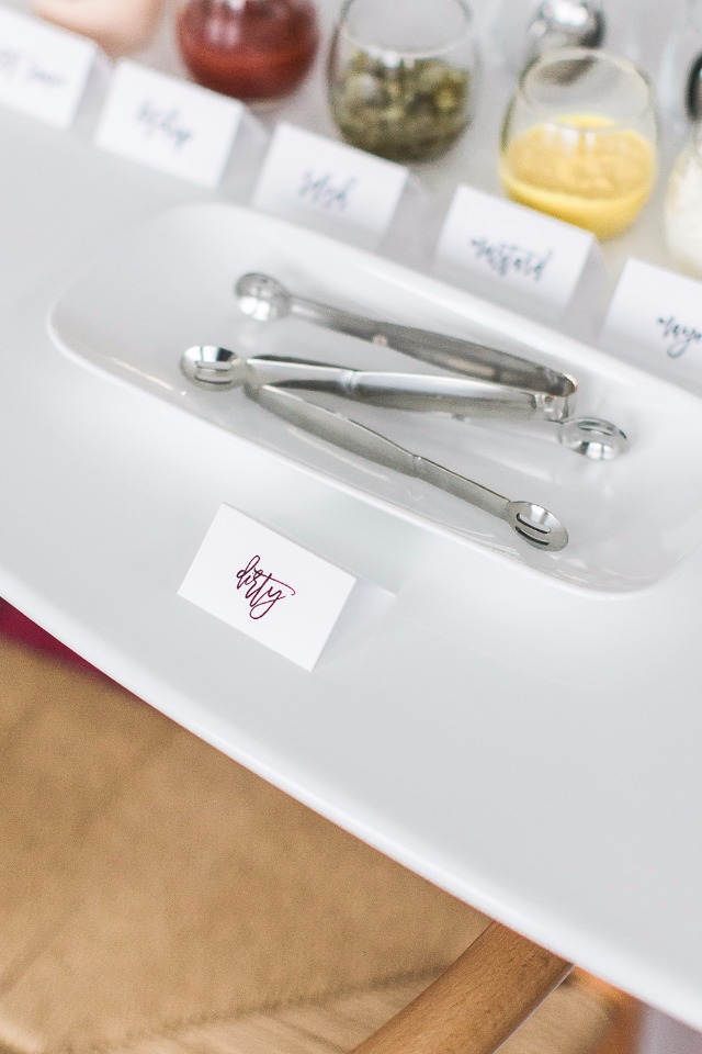 White serving tray with tongs and condiment selection for food