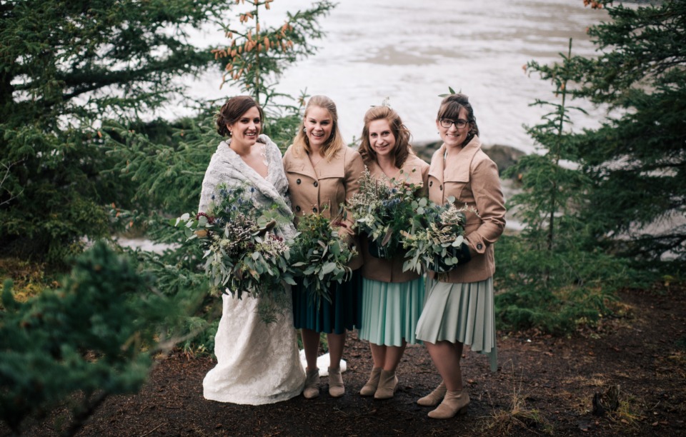 bride and bridesmaids staying cozy