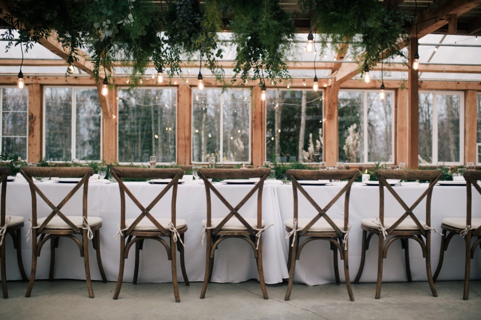 family style seating with modern lighting and greenery table halo