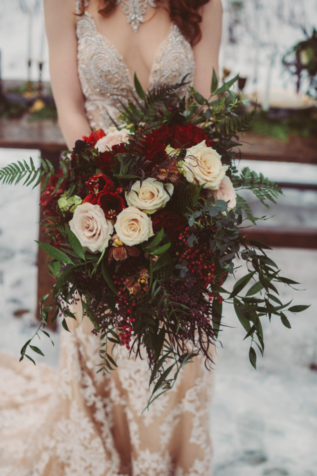white and red wedding bouquet with ferns