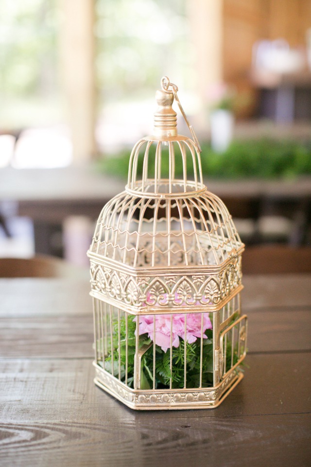 gold bird cage flower arrangement