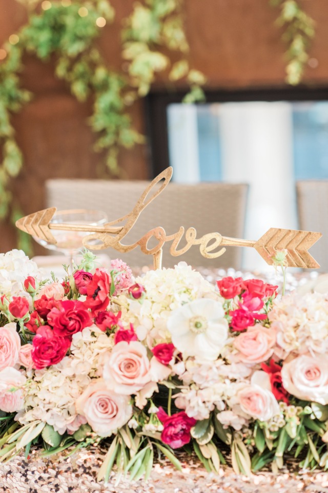 Sweetheart table florals and cute love sign