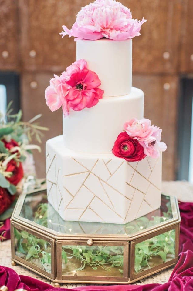 White and gold geometric wedding cake with pink peonies