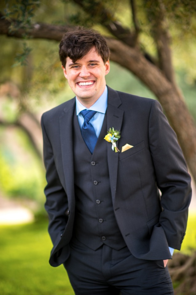 happy groom in three piece suit