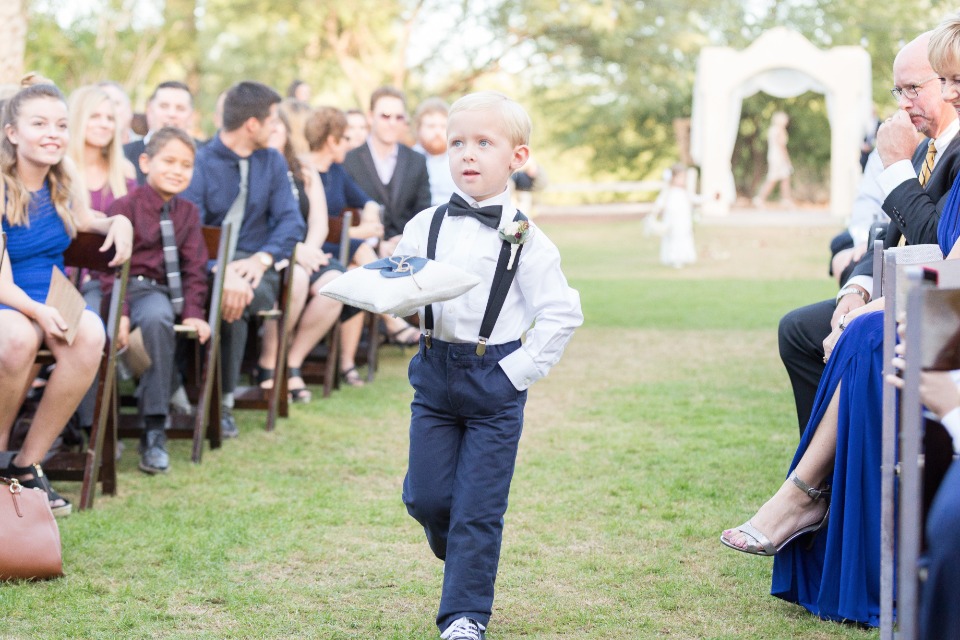 ring bearer in suspenders and bow tie