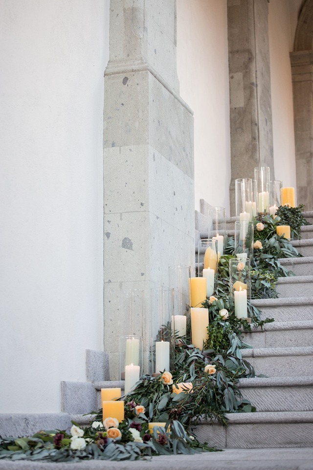 candle and floral garland staircase accent