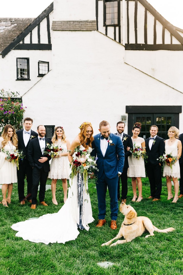 Wedding photo with bride groom and dog on the lawn