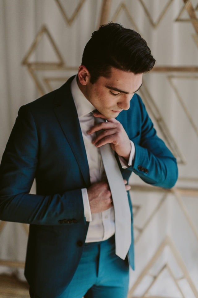 blue wedding suit for the groom in a silver tie