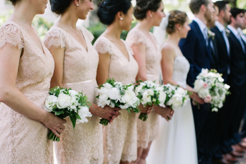 bridemaids in soft peach lace dresses