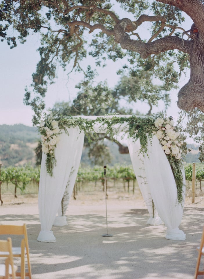 flower covered wedding ceremony arch