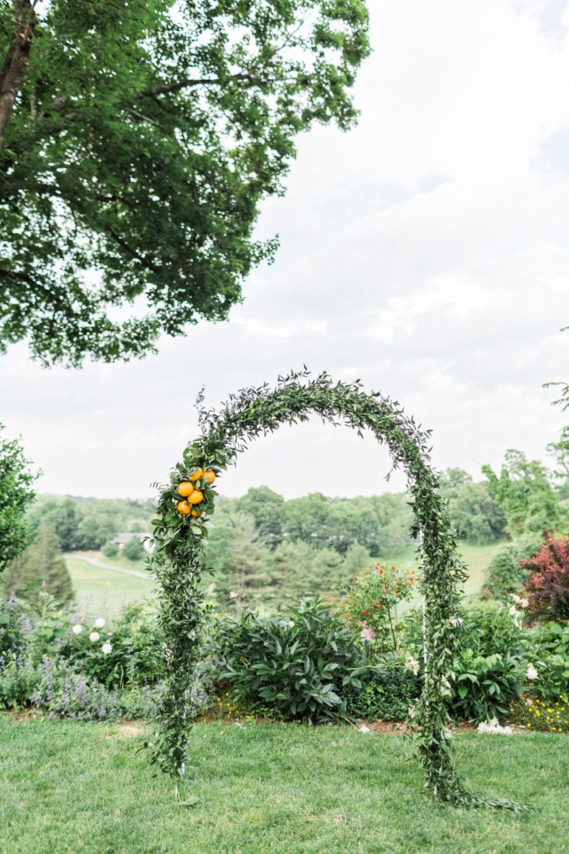 greenery and orange wedding arch