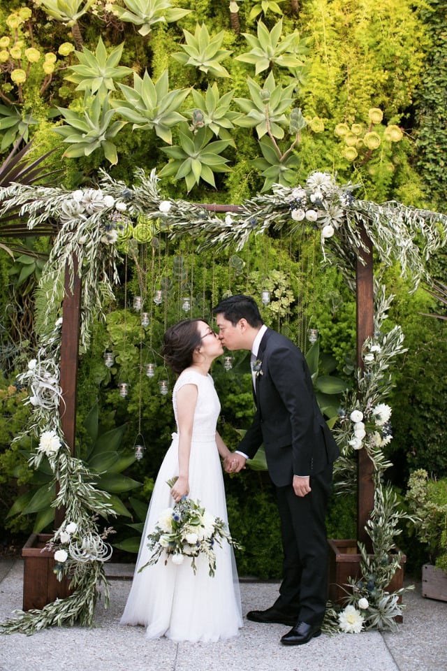 greenery and candle wedding ceremony arch