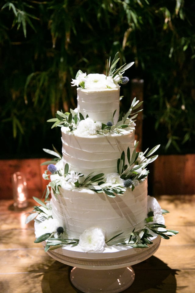 rustic white wedding cake with olive leaves