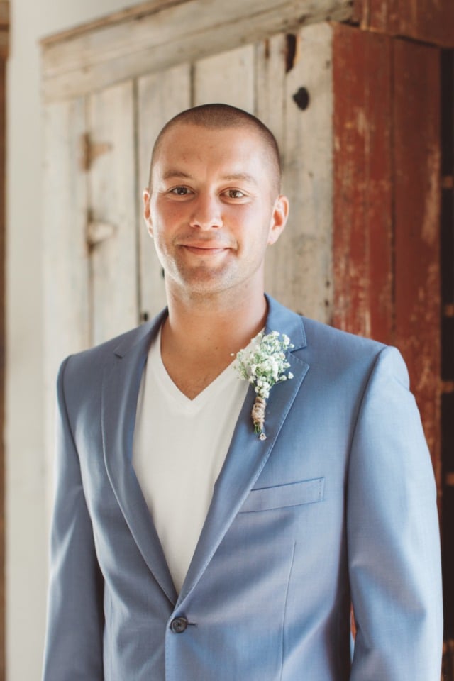 groom in v neck and dusty blue suit
