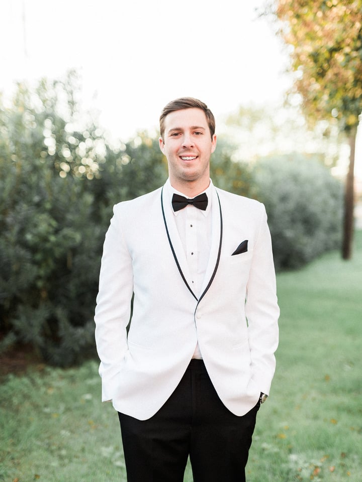 white and black tux groom attire