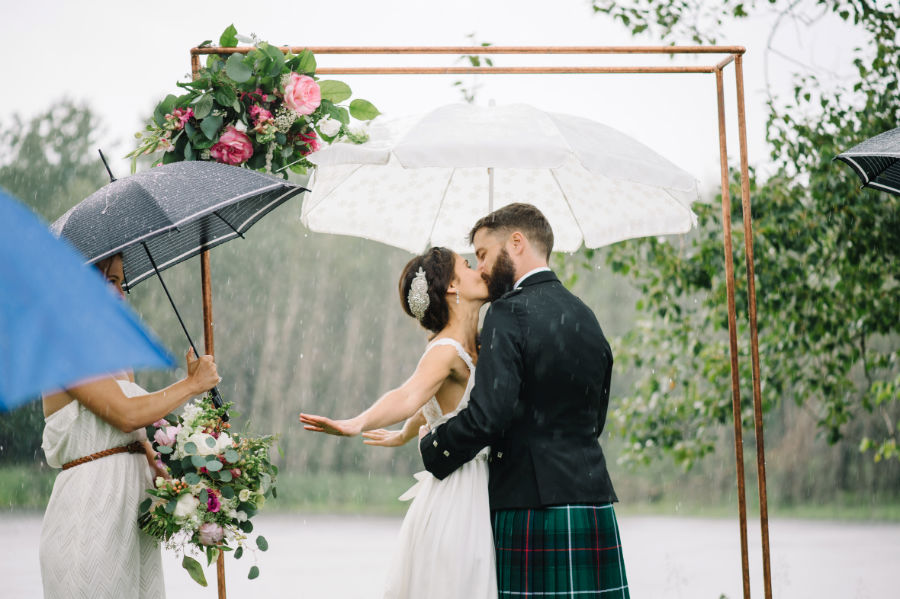 rain soaked wedding kiss