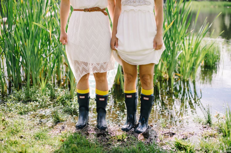 bride and bridesmaid in matching rain boots