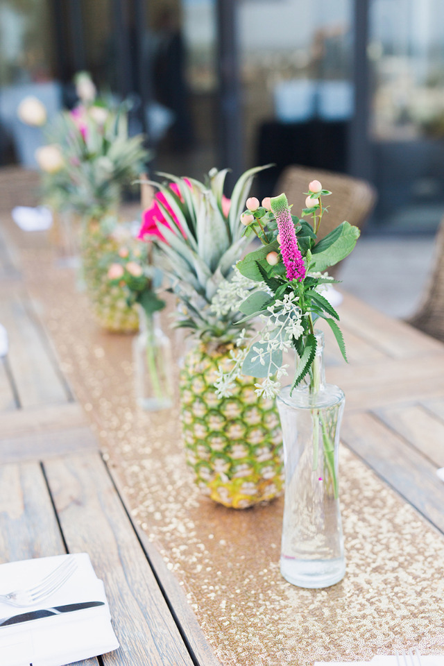 pineapple and bright flowers wedding centerpiece