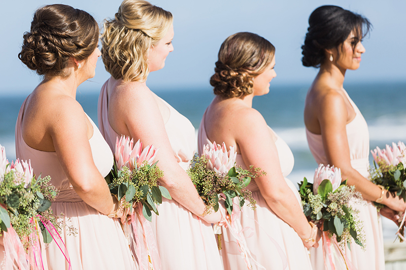 pink bridesmaids with king protea bouquets