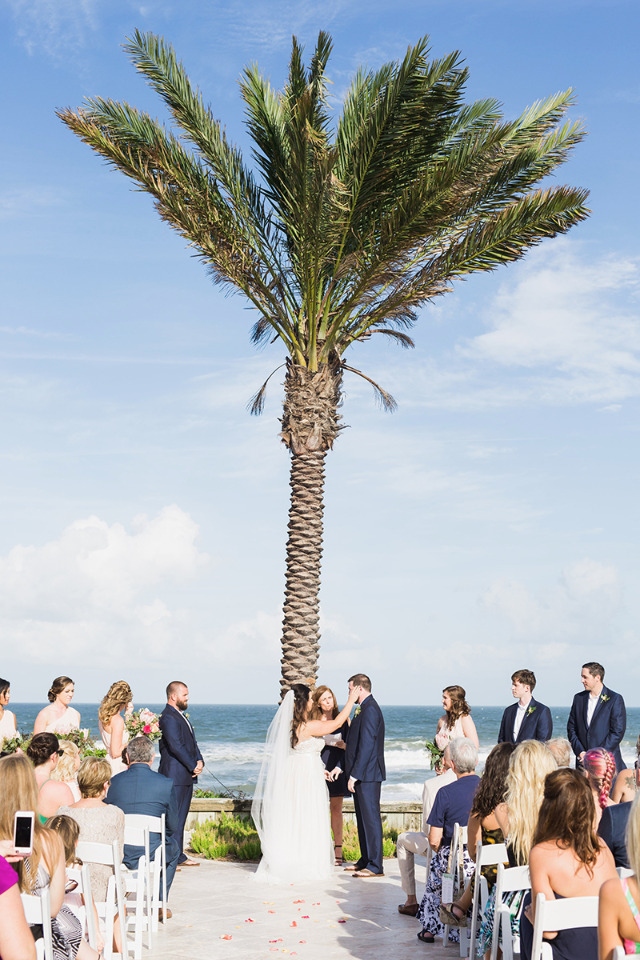 beach wedding with a palm tree backdrop