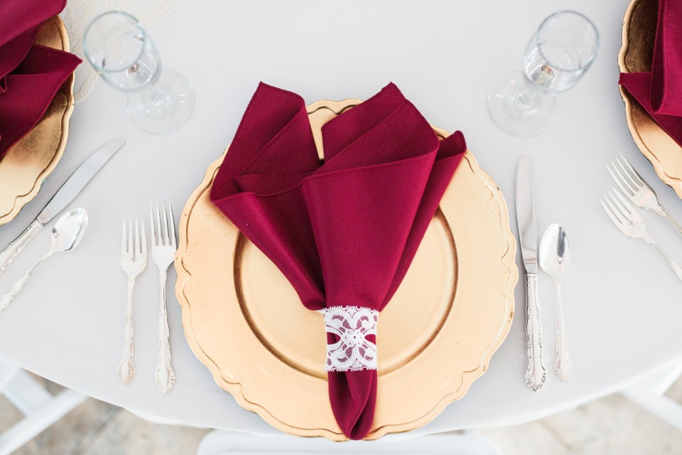 formal table setting for a gold and red wedding