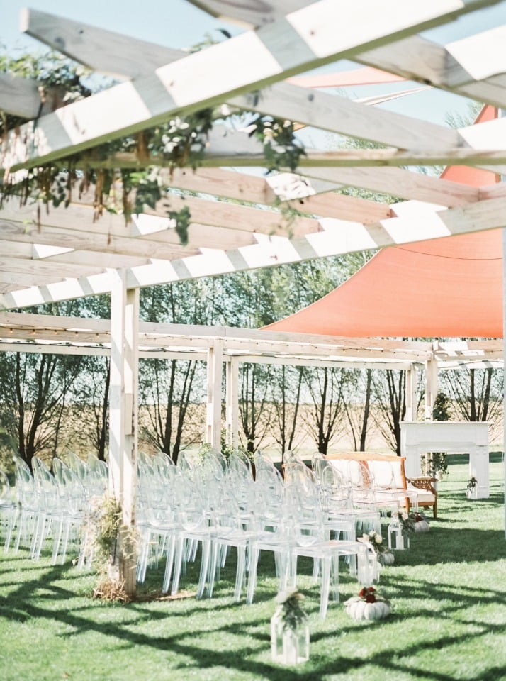 Clear chairs for an outdoor ceremony
