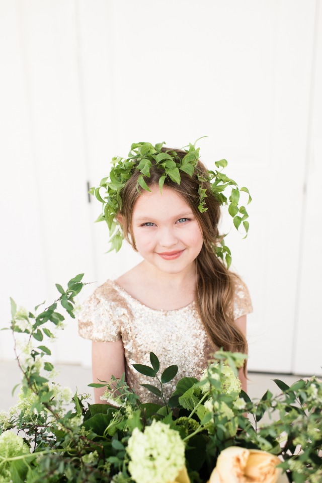 cute little flower girl with greenery halo and gold sequin dress