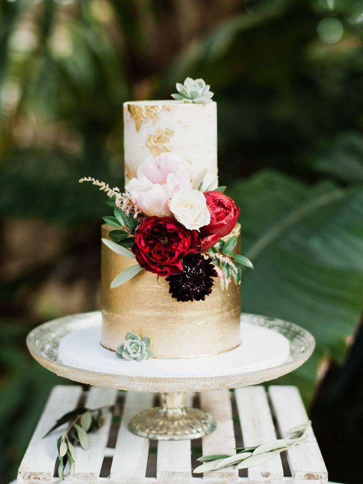 gold flaked wedding cake with flowers