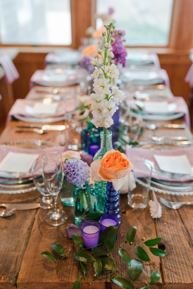 purple and teal wedding table decor with a beach vibe